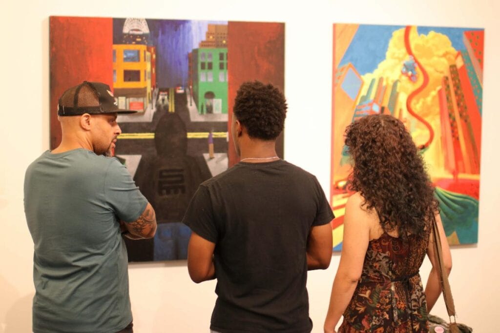 people looking at a painting