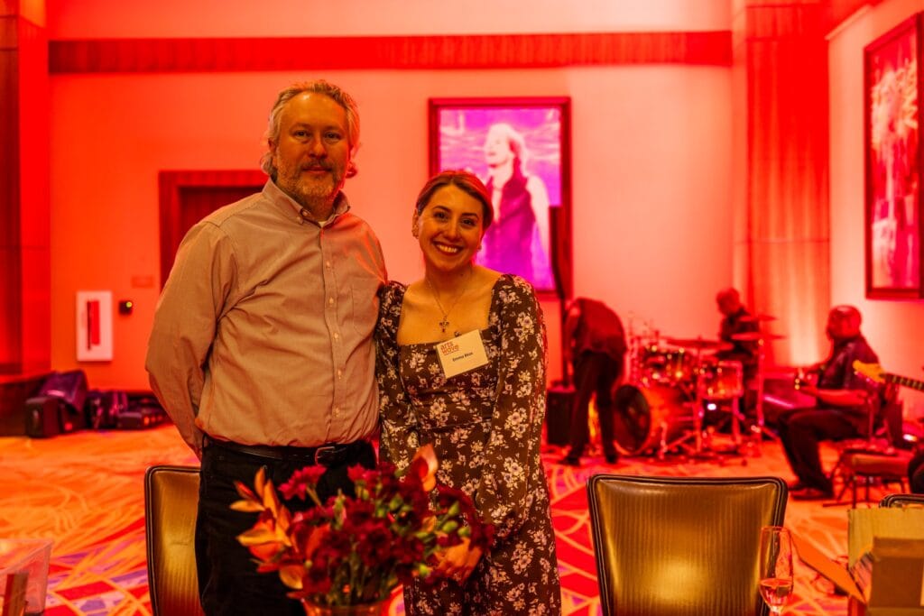 Brightly lit arts event celebrating community arts and performances at ArtsWave, featuring attendees enjoying live music and vibrant art displays in a warm, welcoming atmosphere.