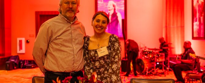 Brightly lit arts event celebrating community arts and performances at ArtsWave, featuring attendees enjoying live music and vibrant art displays in a warm, welcoming atmosphere.