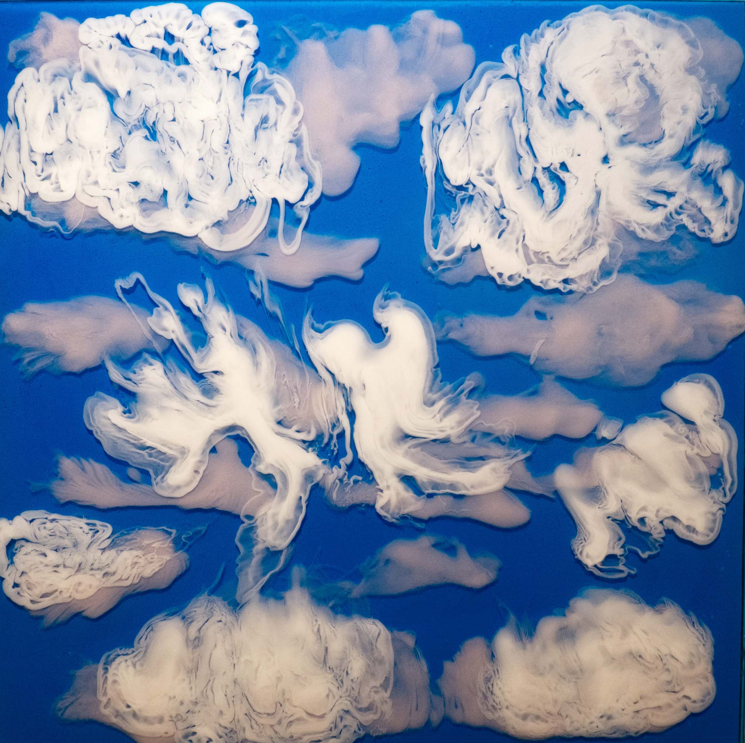 Abstract painting of swirling white clouds against a vibrant blue sky, showcasing dynamic textures and fluid forms.