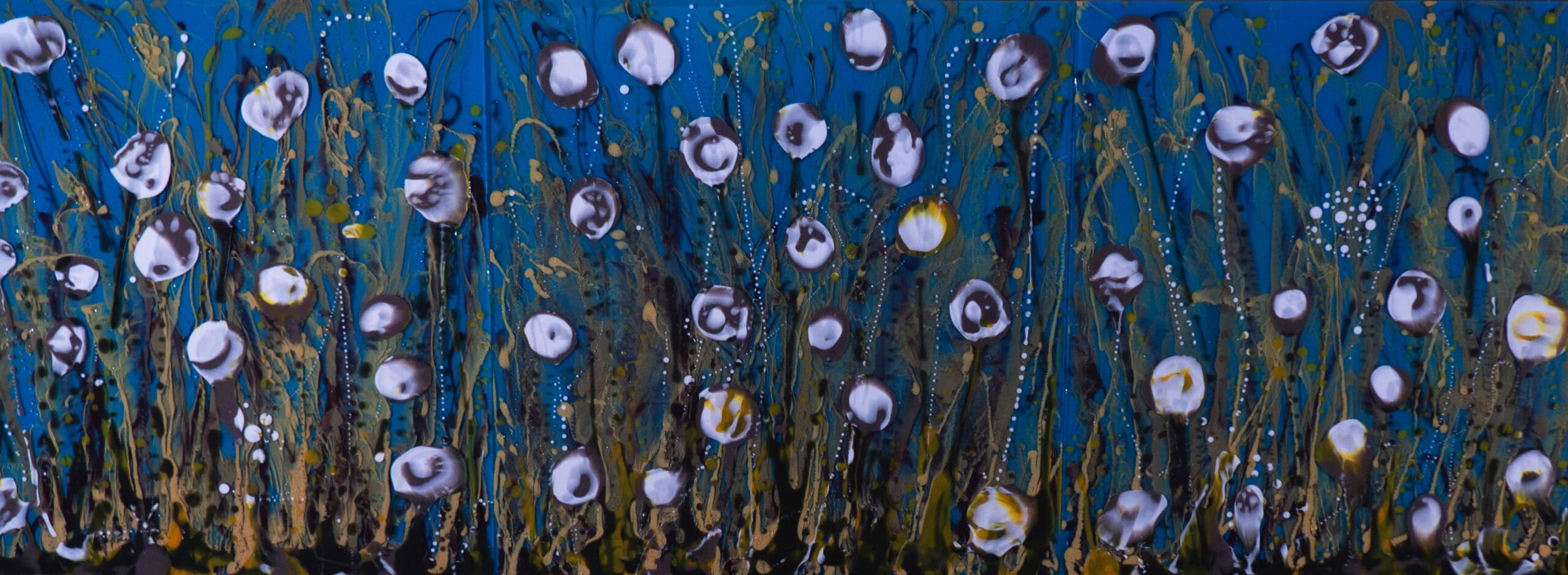 Vibrant outdoor art installation featuring colorful, abstract flowers with blue, purple, and white hues, representing Cincinnati's thriving arts scene and community engagement.